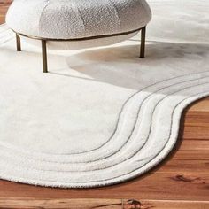 a white rug on top of a wooden floor