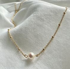 Elevate your style with our exquisite pearl necklace, a timeless piece that effortlessly combines classic elegance with a contemporary twist. Handcrafted with precision and attention to detail, this necklace is a stunning addition to your jewelry collection and a perfect choice for both everyday wear and special occasions. 🐚✨ Note: As each pearl is unique, slight variations in size, shape, and color may occur, ensuring that your necklace is truly one-of-a-kind. Finish: Gold Dipped Adjustable Ch Minimalist Pearl White Pearl Chain Necklace, Minimalist Pearl Charm Chain Necklace, Minimalist Pearl Pendant Jewelry With Round Beads, Everyday Pearl Necklace With Delicate Chain, Simple Pearl Clavicle Chain Necklaces, Minimalist Pearl Chain Necklace With Round Beads, Minimalist Pearl White Pearl Necklace With Clavicle Chain, Minimalist Pearl White Chain Necklace With Pearl Drop, Minimalist Single Strand Pearl Necklace For Anniversary