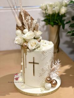 a cake decorated with flowers and feathers on a table