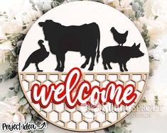 a sign that says welcome with farm animals