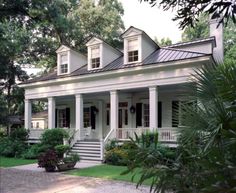 a white house with porches and columns