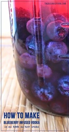 a jar filled with blueberries sitting on top of a wooden table