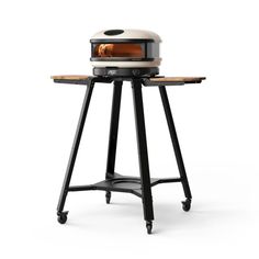 an outdoor pizza oven sitting on top of a table with wheels around it's sides