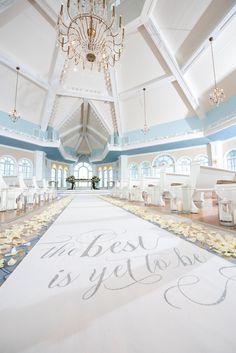 a wedding ceremony with the bride and groom's names written on the floor in white