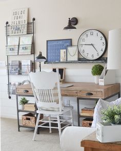 a white chair sitting in front of a desk with a clock on the wall above it