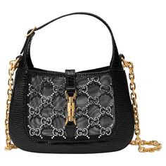 Reinterpretations of House emblems appear throughout the Gucci Aria, enriched with intricate details and precious materials. The collection revisits signature materials, shapes and patterns as a celebration of the brand's 100-year long history. Crafted black lizard leather, this mini crescent moon shaped bag is defined by mesh with GG crystals. A detachable chain strap further accentuates the style with multiple ways to wear. Piston lock at the open top. COLOR: Black MATERIAL: Lizard leather ITE Gucci Aria, Gucci Jackie 1961, Gucci Brand, Gucci Outfits, Gucci Tote, Looks Chic, Gucci Black, Gucci Handbags, Hermes Birkin