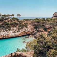 the blue water is surrounded by trees and rocks