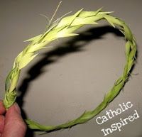 a hand holding a piece of grass with the words catholic inspired written on it