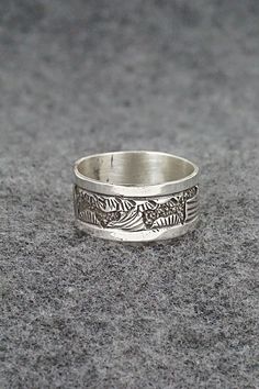 This sterling silver ring featuring a southwest landscape was made by Navajo silversmith Elaine Becenti. The inside is signed B and stamped sterling.Size: 11Width: 3/8"Free shipping on all orders! We ship with USPS and always include tracking. All orders ship within a day of payment.Returns are accepted up to 30 days after you receive your order. Just send us a message. Our shop offers cash back or store credit. The item must be returned in new condition. Southwestern Engraved Round Rings, Southwestern Style Engraved Round Rings, Artisan Sterling Silver Ring With Etched Details, Artisan Sterling Silver Etched Rings, Silver Southwestern Style Rings, Southwestern Silver Rings Collectible, Southwestern Silver Collectible Rings, Southwestern Style Untreated Silver Rings, Collectible Southwestern Silver Ring