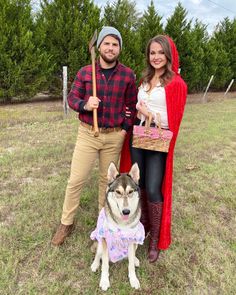 a man and woman standing next to a dog