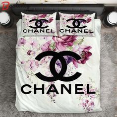 a chanel bed set with pink flowers on it