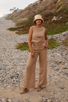 Style // A beautiful brown linen top, the perfect addition to any wardrobe The Mila Top is the perfect effortless and minimal design for the ultimate laid back look. A high neck sleeveless linen top, featuring a mother of pearl button on the back. The rounded neckline can be dressed up or down, making it your new go to top Fabric Note // Made in Italy from 100% Linen Sizing Advice // Available in three sizes, S: Bust: 36" Length: 20" M: Bust: 38" Length: 21" L: Bust: 40" Length: 22" Care Instruc Brown Sleeveless Linen Top, Sleeveless Brown Linen Top, Brown Linen Tops For Vacation, Postpartum Pants, Linen Matching Set, Brown Linen Pants, Clothes Basket, High Neck Sleeveless, Wide Leg Linen Pants