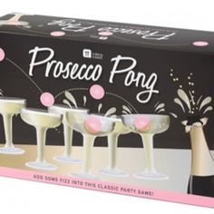 three champagne flutes are in front of a black box with pink confetti on it