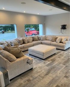 a living room filled with furniture and large windows