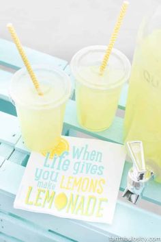 two lemonade drinks sitting on top of a blue bench next to a sign that says when life gives you lemons make lemonade