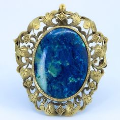 "Beautiful floral detailing in this vintage convertible brooch / pendant. Beautifully crafted 10k Gold setting with large polished lapis cabochon. Fold away bale. This piece has no markings. Chain not included - Need one? Just ask, we can help. Length of Brooch 1.80\" Length of pendant including bale 2.0\" Width of Brooch 1.54\" Lapis measurements 29.5x23 mm Weight of piece 0.48 Oz (13.62 g) CHAIN NOT INCLUDED - FOR DISPLAY ONLY This item is vintage. It has been cherished, worn, and preserved by Ornate Gemstone Brooches For Collectors, Art Nouveau Filigree Brooch For Collectors, Collectible Art Nouveau Filigree Brooches, Vintage Convertible, Brooch Art, Unique Rings Vintage, Lapis Pendant, Nouveau Jewelry, Art Nouveau Jewelry