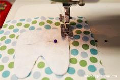 the sewing machine is working on an elephant shaped piece of paper that has been sewn