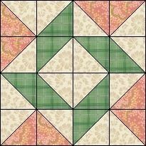 a green and white quilt with pink flowers on it