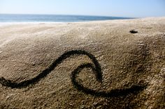 a heart drawn in the sand at the beach