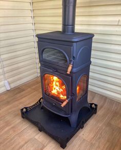 a wood stove sitting on top of a hard wood floor