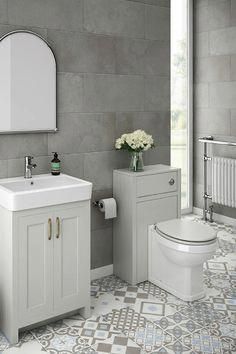 a bathroom with a toilet, sink, mirror and radiator on the wall