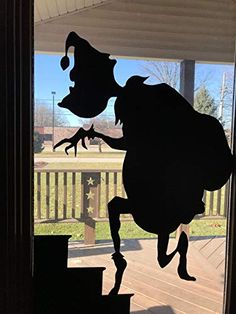 the shadow of a person in a hat is seen through a glass door on a porch