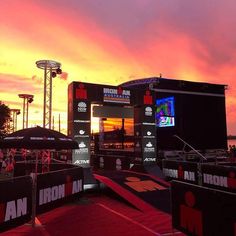 the stage is set up for an iron man show at sunset with people standing on it