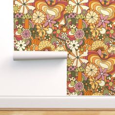 an orange and green wallpaper with flowers on it