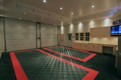 a garage with black and white checkered flooring in front of a flat screen tv