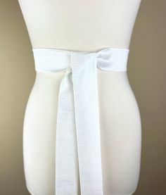 "Narrow Textured White Sash  White Dupioni Sash Belt  White Dress Sash Belt  White Fabric Belt  White Wedding Dress Sash Add rich texture to your special occasion outfit with this Satin Swank® dupioni waist sash. Depending on your waist size and the length you choose (75 and 90 inch lengths available), you can wrap this sash around your waist once or twice. You decide whether to tie the sash in a bow or a simple knot with long-hanging tails. Tie in front, in back, or on the side. A double layer White Bridal Belt With Sashes For Bridesmaid, White Bridal Sash Belt For Bridesmaid, White Embellished Fitted Sash, Fitted White Bridal Belt, White Satin Bridal Belt With Sashes, White Sash, Waist Sash, Tie Women, Wedding Dress Sash