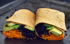 two burritos filled with black beans and avocado