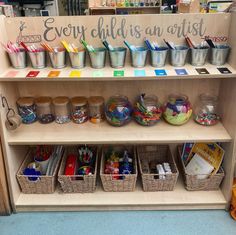 there are many baskets and bins on the shelf in this store that is filled with children's art supplies