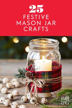 a jar filled with candles sitting on top of a table next to christmas decorations and lights