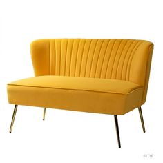 a yellow couch sitting on top of a white floor next to a metal legrest