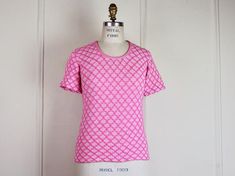 super fun shirt from the 1970s. hot pink argyle patterned double knit.  scoop neck.  short sleeves.  tight and fitted and super cute!!!tagged ♥ 75% orlon, 25% antronmachine wash and drymeasurements ♥ best fits: small to mediumshoulder seam to shoulder seam: 13.5 inchesbust: 15.5 incheswaist: 15 incheships: 16 inchessleeve, from top of shoulder to cuff: 7.5 incheslength: 23.5 inchesmeasurements are taken flat from resting point to resting point. multiply by 2 for bust, waist and hips. there is a Pink Argyle, Couture Looks, Argyle Pattern, Fun Shirt, Star Dress, Double Knit, Knit Shorts, Double Knitting, Scoop Neckline