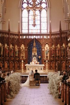 the bride and groom are sitting at the alter