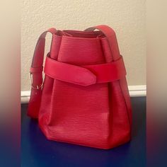 Excellent Condition With Minor Wear In Corners And A Small Stain On The Interior As Shown. No Smell- Well Taken Care Of Bag! This Chic Louis Vuitton Red Epi Leather Sac D'epaule Pm Bag Is Rare And Can No Longer Be Purchased In Stores. It Features A Unique Shape With A Leather Band And Press Stud Closure With A Spacious And Accessible Interior. You Will Love Carrying This Sophisticated Bag Everywhere You Go! The Louis Vuitton Epi Leather Collection Was First Introduced In 1985 And Was Created To Red Evening Bucket Bag With Dust Bag Included, Designer Red Shoulder Bag For Formal Occasions, Red Bucket Bag For Evening With Dust Bag, Designer Red Bucket Bag For Formal Occasions, Luxury Red Bucket Bag For Travel, Red Formal Bucket Bag With Adjustable Strap, Elegant Red Bucket Bag For Formal Occasions, Modern Red Bucket Bag For Formal Occasions, Formal Red Bucket Bag With Adjustable Strap