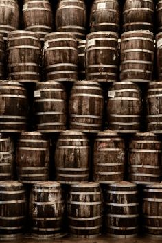 many wooden barrels stacked on top of each other