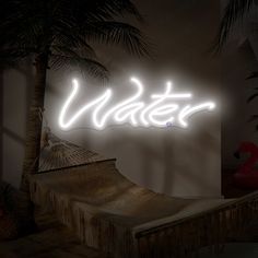 a neon sign that reads water in front of a palm tree and pool floater