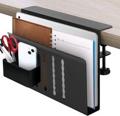 an office desk with several compartments for pens, papers and scissors