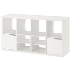 a white bookcase with four compartments and two doors