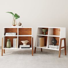 two bookshelves with different types of vases on them and one has a plant in it