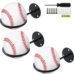 two baseball shaped mirrors with screws and toothbrushes next to eachother