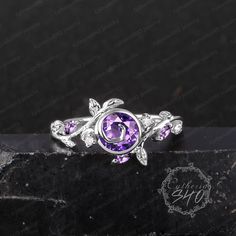 Vintage amethyst engagement ring Art deco 14K white gold bezel promise ring Unique nature inspired elven leaf ring Her Handmade jewelry gift Engagement ring Center Stone: Amethyst Cut: Round cut Size: 6mm Side stone: Moissanite + Amethyst Color: D-F  Clarity: VVS1 Weight: 0.212ctw Width: 1.5mm Thickness: 1.2mm Wedding band Stone: Moissanite + Amethyst Weight: 0.292ctw Width:1.5mm Thickness: 3.6mm Ring Metal: 925 sterling silver or 10K/14K/18K Yellow/ White/Rose Gold or platinum  Processing time Elegant Silver Amethyst Ring With Bezel Setting, Silver Amethyst Jewelry With Bezel Setting, Dainty White Gold Amethyst Jewelry, Dainty Amethyst White Gold Jewelry, Dainty Amethyst Jewelry In White Gold, Silver Amethyst Wedding Ring With Bezel Setting, Silver Amethyst Promise Ring With Bezel Setting, White Gold Amethyst Jewelry For Anniversary, Elegant Amethyst Flower Ring For Anniversary