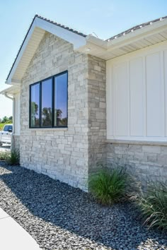 a house that is made out of stone and has two windows on the side of it