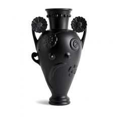 a black vase with flowers on it