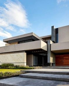 a modern house with concrete steps leading up to it