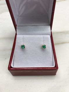 AAA+ fine quality Colombian emerald studs set in 14K yellow gold. vivid-green emeralds with incredible transparency, accented by a simple double-prong 14k yellow gold mount, allowing for the emerald to be shown in full view. The earth mined, green Colombian emeralds have a desirable lush green color with excellent qualities. These earrings are ideal for everyday use and are the perfect accessory to any outfit. Total Carat Weight: 0.24tcw Setting Style: Double Prong Setting Material: 14K Yellow, May Birthstone Earrings With Prong Setting In Round Cut, May Birthstone Round Cut Earrings With Prong Setting, Classic Round Earrings For May Birthstone, Fine Jewelry Earrings For May Birthstone, May Birthstone Earrings With Prong Setting, Classic Round May Birthstone Earrings, 14k Gold Hallmarked Round Cut Earrings, Classic Round Diamond Earrings For May Birthstone, Yellow Gold Birthstone Earrings With Round Cut