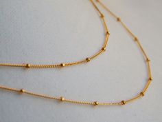 CHAIN NECKLACE | SATELLITE CHAIN LAYERING NECKLACE A delicate long gold necklace. This tiny beaded, gold chain necklace is lovely alone or as a beautiful gold layering necklace. ✦ 14K Gold Filled, Sterling Silver or Two Tone Sterling Silver with Gold Filled Beads ✦ Beaded Satellite Chain - Made to order at the length you choose Photo #6 is our newest mixed metal satellite chain: Sterling Silver with Rose Gold Filled Beads (see Rose/Silver in drop down menu for this choice) UPGRADE TO A LOBSTER C Delicate Link Chain Necklace With Satellite Chain, Double Strand Satellite Chain Necklace As Gift, Gift Satellite Chain Double Strand Necklace, Dainty Chain Necklace, Jupiter Fl, Gold Long Necklace, Gold Necklace Layered, Chain Choker Necklace, Layering Necklace