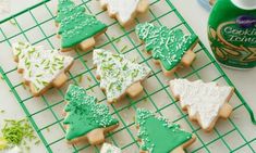 cookies decorated with green and white icing on a cooling rack